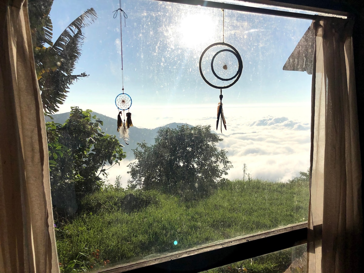 Above the clouds — the earthship sits high enough that the valley below sometimes disappears under cloud