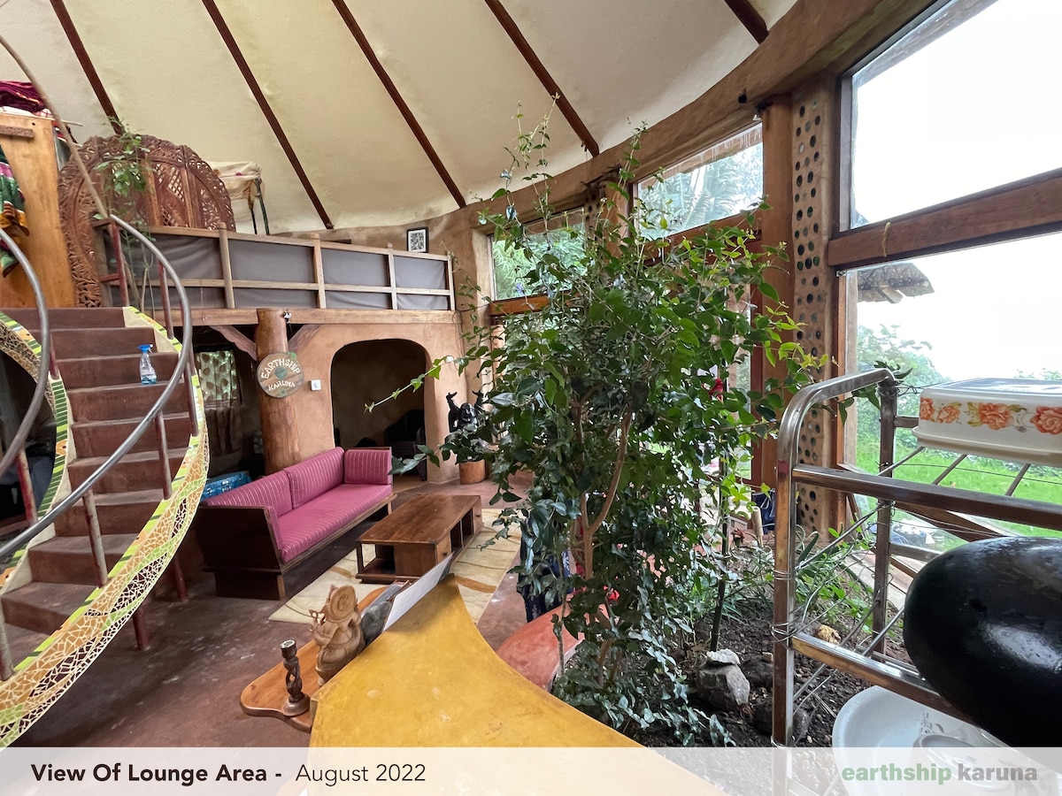 The lounge area with hand-sculpted earth walls and soft natural light